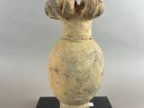 a vase that is sitting on top of a black stand