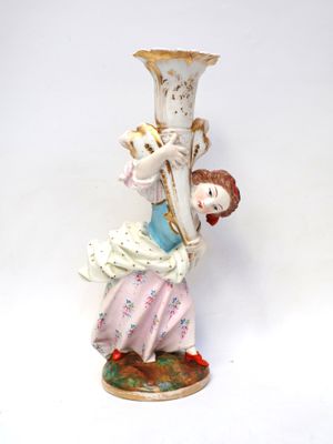 a figurine of a woman holding a vase