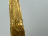a close up of a gold pen with a white background