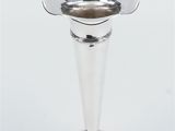 silver plated candle holder with a flower design on the base