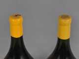 two bottles of wine with a cork stopper on top of them
