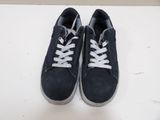 navy blue and white sneakers with white laces on a white surface