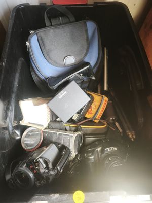 a bin full of cameras and other items in it