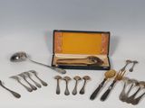 a lot of silver spoons and forks in a box