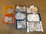 many different types of rocks in boxes on the floor