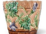 an image of a ceramic planter with flowers on it