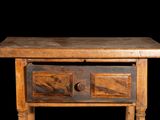 a small wooden table with two drawers on it