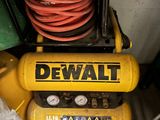 a yellow air compressor sitting on top of a table