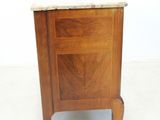 a small wooden cabinet with a marble top