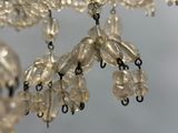 a chandelier made of glass beads hanging from the ceiling