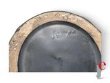 a black plate with a brown rim on a white background