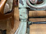 a chair that has a wooden seat and a wooden arm rest