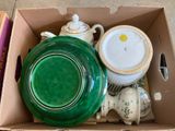 a box full of green and white dishes and cups