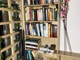 a bookshelf with a bunch of books on it in a room