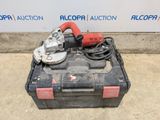 a black box with a red cord and an electric tool in it