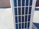 an air conditioner sitting on top of a pallet in a parking lot