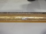 a mirror that has a gold frame on it
