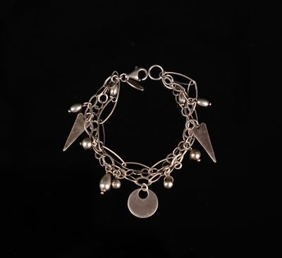 un bracelet en argent orné de breloques sur fond noir