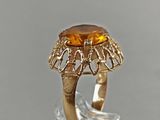 an image of a gold ring with a large citrine stone