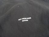 the back of a black shirt with white writing that says hot from paris madame