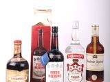 several bottles of liquor are lined up on a white surface