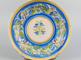 an image of a blue and yellow plate with flowers on it