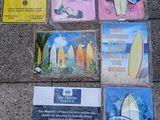 many signs on the sidewalk that are posted on the sidewalk