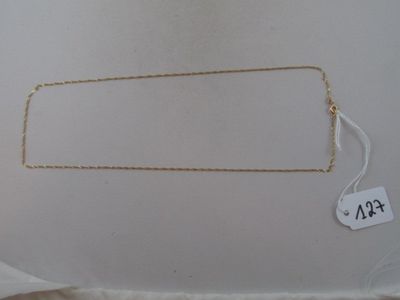 the necklace is gold and has a price tag on it