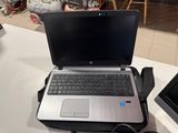 a laptop computer sitting on top of a table next to a monitor