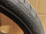 a close up of a tire on a wooden surface with a cardboard box in the background