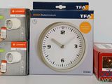 three boxes of tea and a clock sitting on a table
