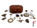a small box with a lot of jewelry on it