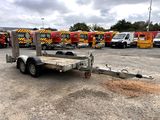 a trailer that is parked in a lot with other trucks in the background