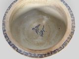 bowl with a bird on the rim and a bird on the rim