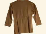the back of a brown shirt on a hanger on a white wall