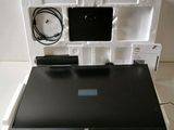 a laptop in a white box with a charger on it