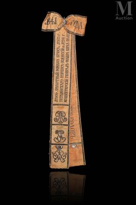 a wooden bookmark with a ribbon on top of it