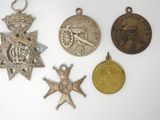 several medals and medals are displayed on a white surface
