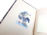 an open book with a picture of a mountain on it