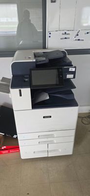 a multi - function printer sitting on the floor in front of a window