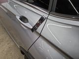 a close up of a car door handle with a sticker on it