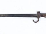 a close up of a knife on a white surface with a hook