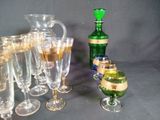 many glasses and a bottle of wine on the table