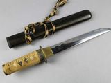 a knife that is laying next to a knife on a table