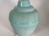 a blue vase that is sitting on a table
