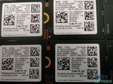 four cell phones with qr code on them sitting next to each other