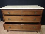 an antique chest of drawers with marble top