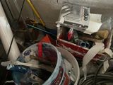 a bucket of paint and other items on the floor