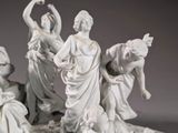 a statue of a group of people that are sitting on the ground