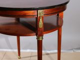 a small round table with a brass plate on top of it